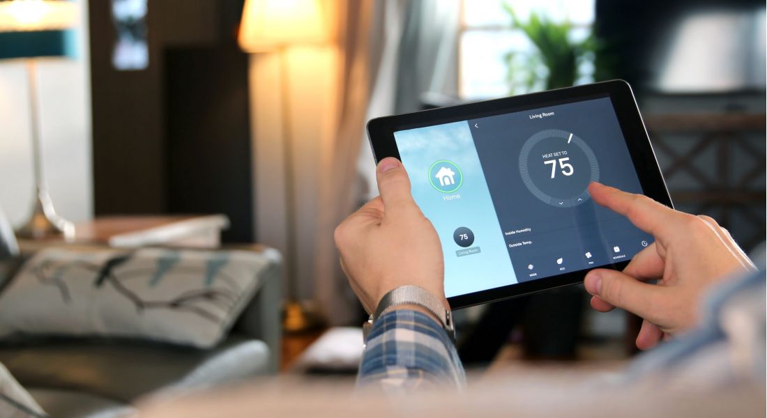A man holding a smart home technology device