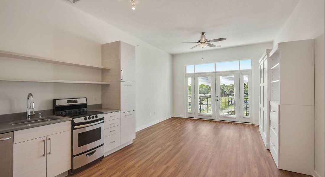 Avenue 80 Apartments living room with large windows and wood floors and beautiful finishes