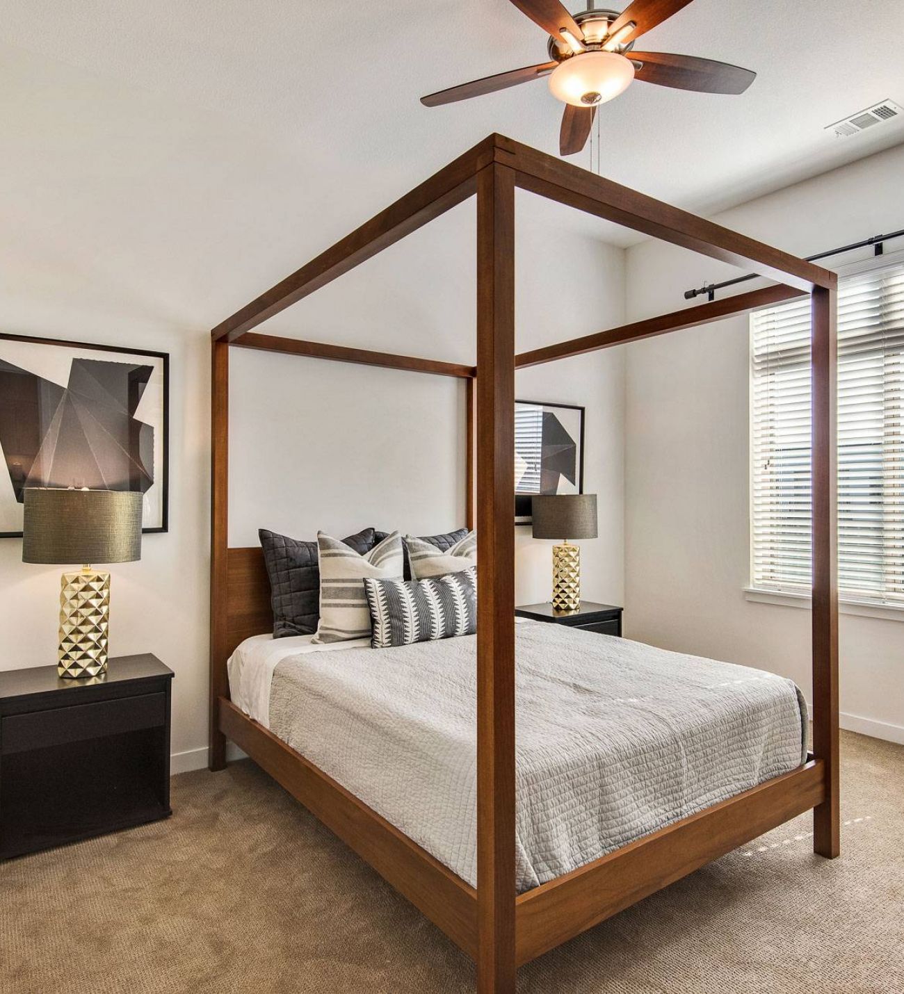Avenue 80 apartments in Overland, KS spacious bedroom with carpet floor, ceiling fan, and large window letting in natural light.